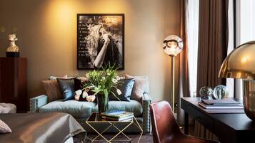 A modern living room with a sofa, coffee table, and a lamp.
