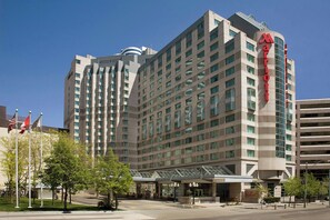 A multi-story hotel with a prominent 'Marriott' sign, featuring a modern architectural design with a glass facade and a covered entrance area. - Marriott Downtown at CF Toronto Eaton Centre (Toronto)