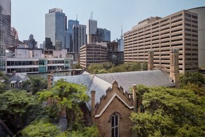 A cityscape with a mix of modern and historic buildings, including a prominent parking garage and a church with a pointed roof. - Marriott Downtown at CF Toronto Eaton Centre (Toronto)