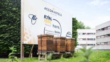 A billboard advertising Accor Hotels with a message about bees and honey.