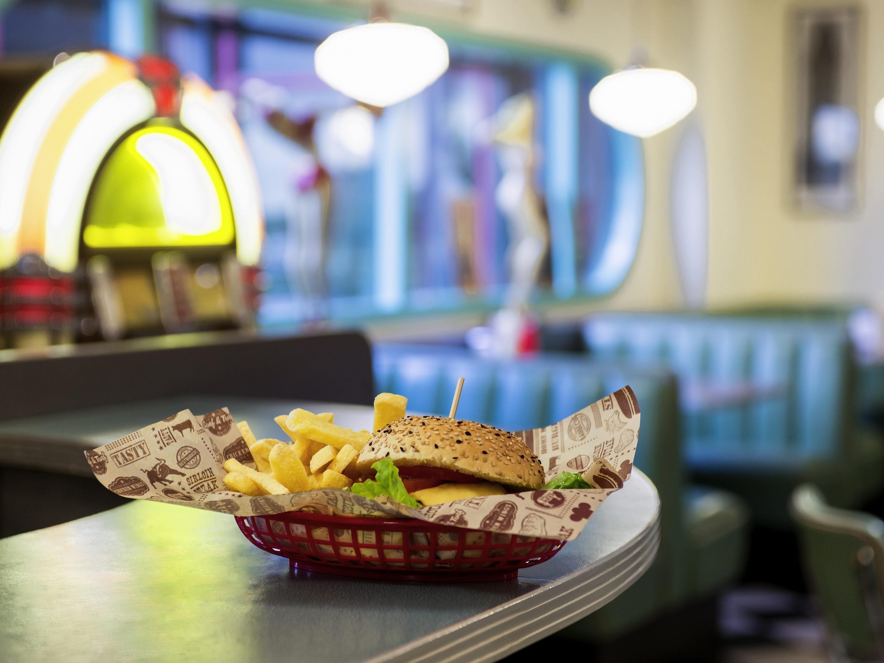 A basket with a burger and fries on a table in a restaurant.