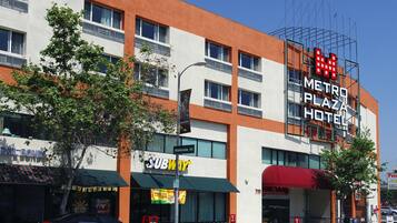 A hotel with a modern facade, multiple windows, and a prominent sign for the Metro Plaza Hotel.