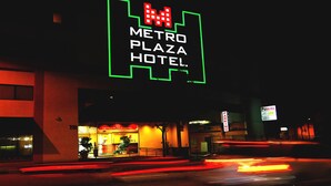The exterior of the Metro Plaza Hotel with a prominent neon sign. - Metro Plaza Hotel (Los Angeles)