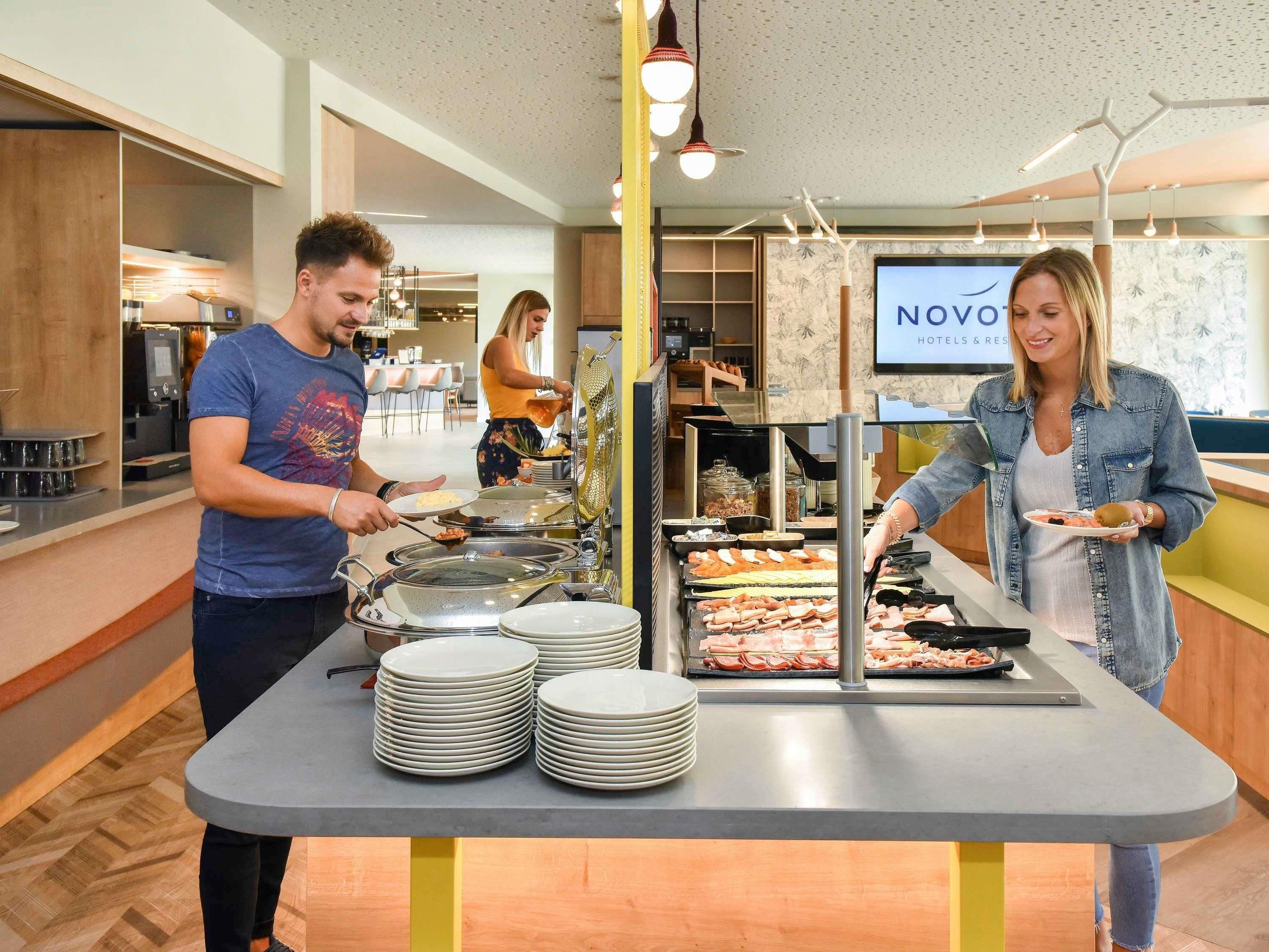 A buffet setup with multiple food stations and a counter with plates.