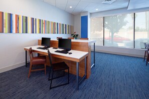 A modern office space with a long table, two chairs, and two computer monitors. - Holiday Inn Express Los Angeles Airport by IHG (Los Angeles)