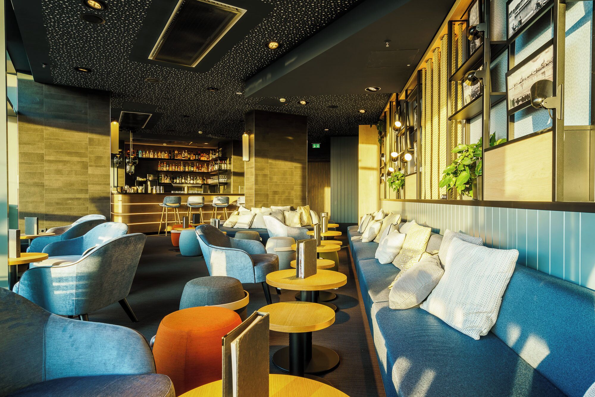 A modern bar area with seating and a bar counter.