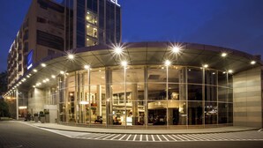 A Novotel hotel with a modern glass facade, a prominent sign, and a well-lit entrance.