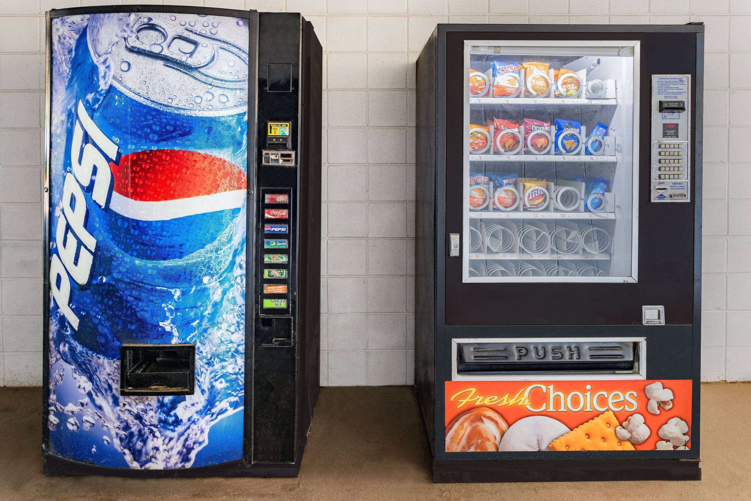 Two vending machines, one with a Pepsi logo and the other with a Fresh Choices label.