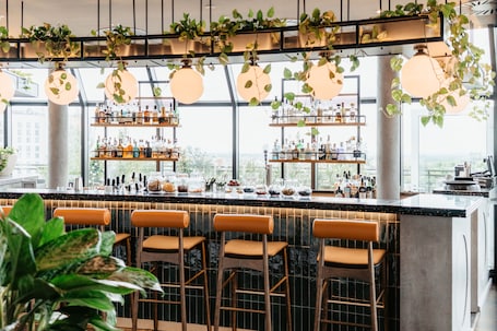 Rooftop bar, garden views, open daily. Wasserturm Hotel Cologne, Curio Collection by Hilton