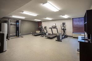 A fitness center with treadmills, a weight machine, and a wall-mounted exercise bike. - Holiday Inn Express Newark Airport Elizabeth by IHG (Elizabeth)