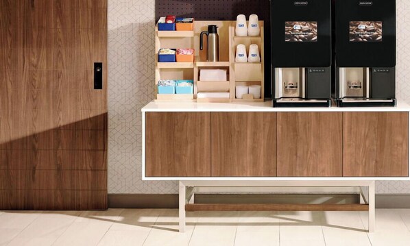A modern kitchen with wooden cabinets, a white countertop, and two coffee machines. - Holiday Inn Express Newark Airport Elizabeth by IHG (Elizabeth)
