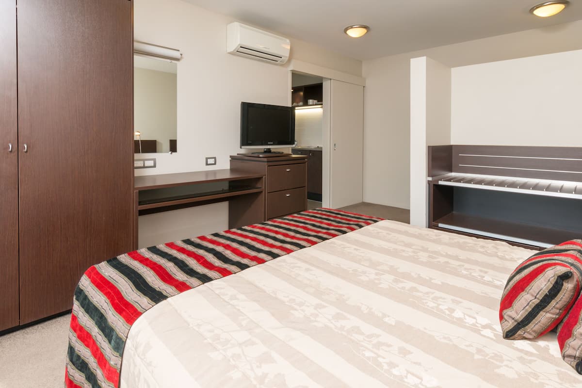 junior suite | in-room safe, desk, blackout curtains, iron/ironing board