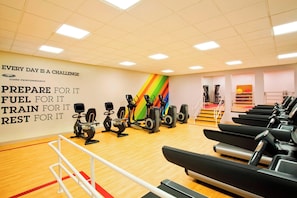Stay active and motivated in our well-equipped gym featuring stationary bikes, elliptical machines, and treadmills.