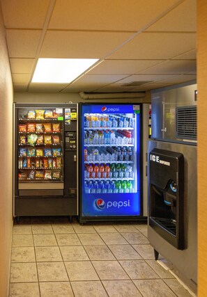 Convenient vending area with snack and drink machines, and an ice dispenser.