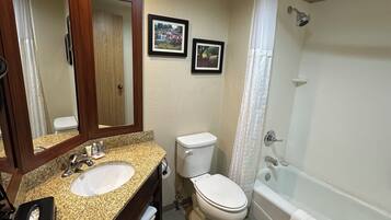 A bathroom with a sink, toilet, and bathtub.