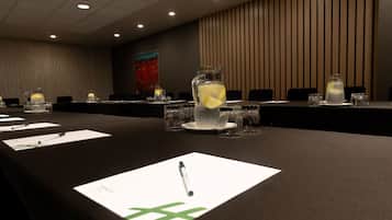A conference room with a long table, name cards, and a pitcher of water with lemon slices.