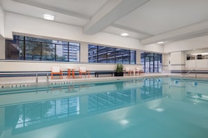 Una piscina techada, sillones reclinables de piscina