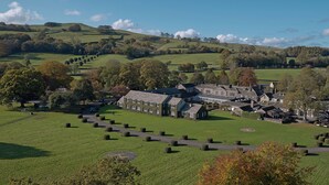 A large estate with multiple buildings, a well-maintained lawn, and a cemetery. - The Devonshire Arms Hotel (Skipton)
