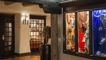 A traditional Japanese-style interior with tatami flooring, a wooden door, and a display window featuring traditional attire and accessories.