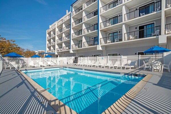 Seasonal outdoor pool, open 9:00 AM to 9:00 PM, pool umbrellas