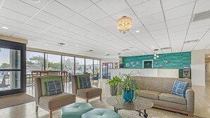 A spacious lobby with a large seating area, a reception desk, and a view of the city. - Best Western Plus Ocean City (Ocean City)