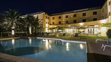 Seasonal outdoor pool, open 9:00 AM to 8:00 PM, pool umbrellas