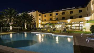 Seasonal outdoor pool, open 9:00 AM to 8:00 PM, pool umbrellas