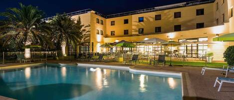 Seasonal outdoor pool, open 9:00 AM to 8:00 PM, pool umbrellas