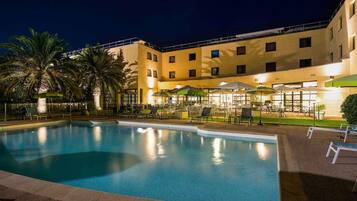 Seasonal outdoor pool, open 9:00 AM to 8:00 PM, pool umbrellas