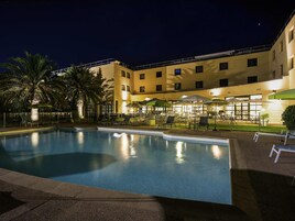 Seasonal outdoor pool, open 9:00 AM to 8:00 PM, pool umbrellas