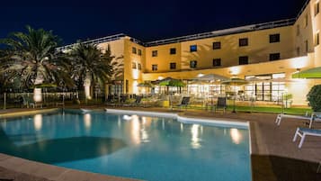 Seasonal outdoor pool, open 9:00 AM to 8:00 PM, pool umbrellas