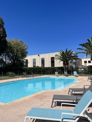 Seasonal outdoor pool, open 9:00 AM to 8:00 PM, pool umbrellas