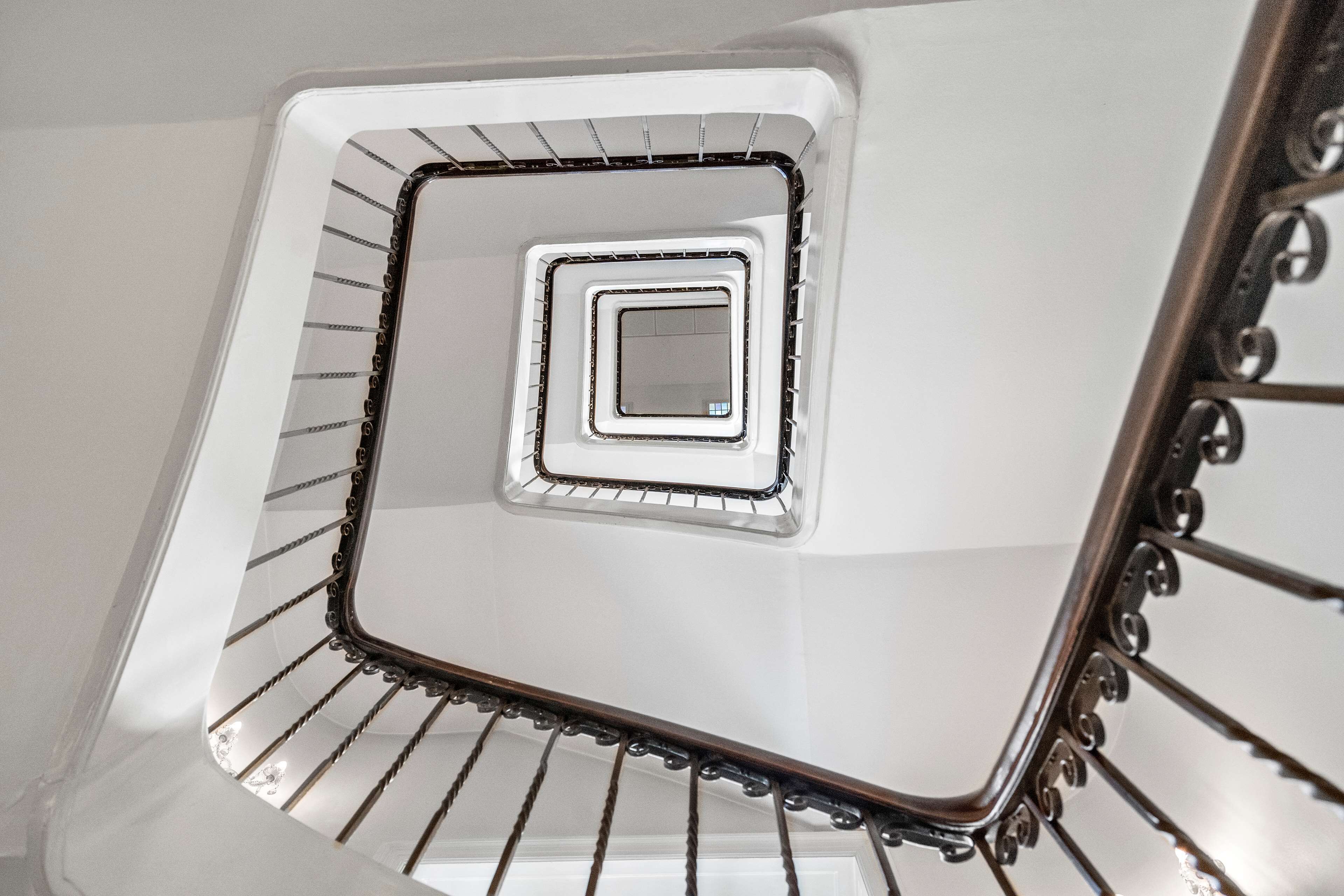 A spiral staircase with a central square window.