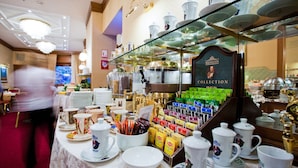 A buffet area with a variety of food and drink options, including a selection of teas and coffee.