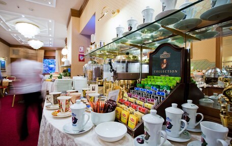 A buffet area with a variety of food and drink options, including a selection of teas and coffee.