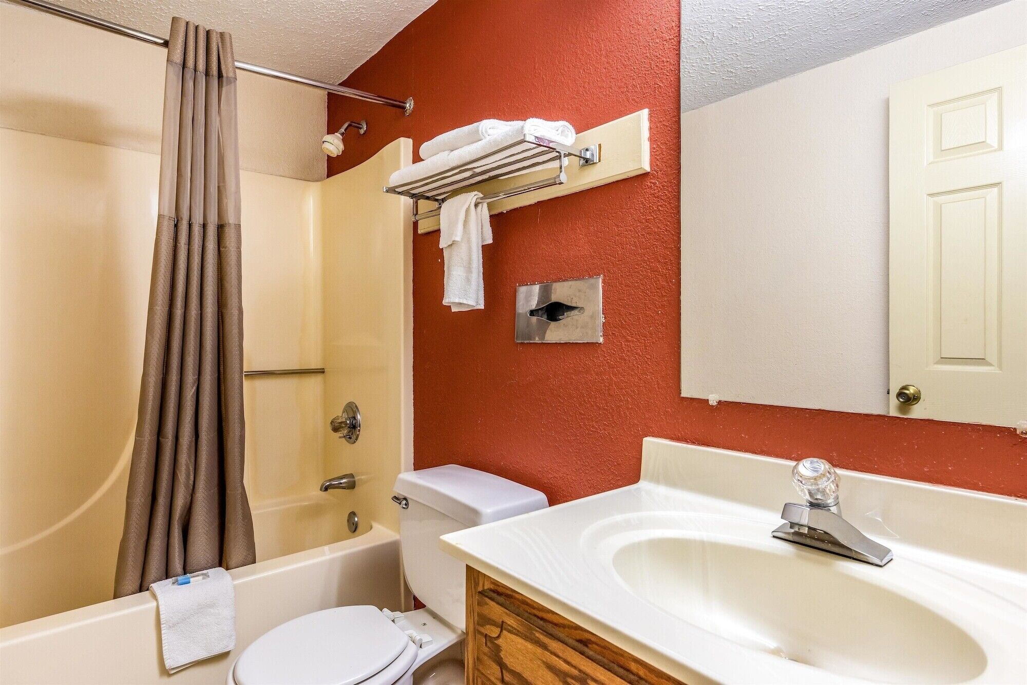 A bathroom with a bathtub, toilet, and sink.