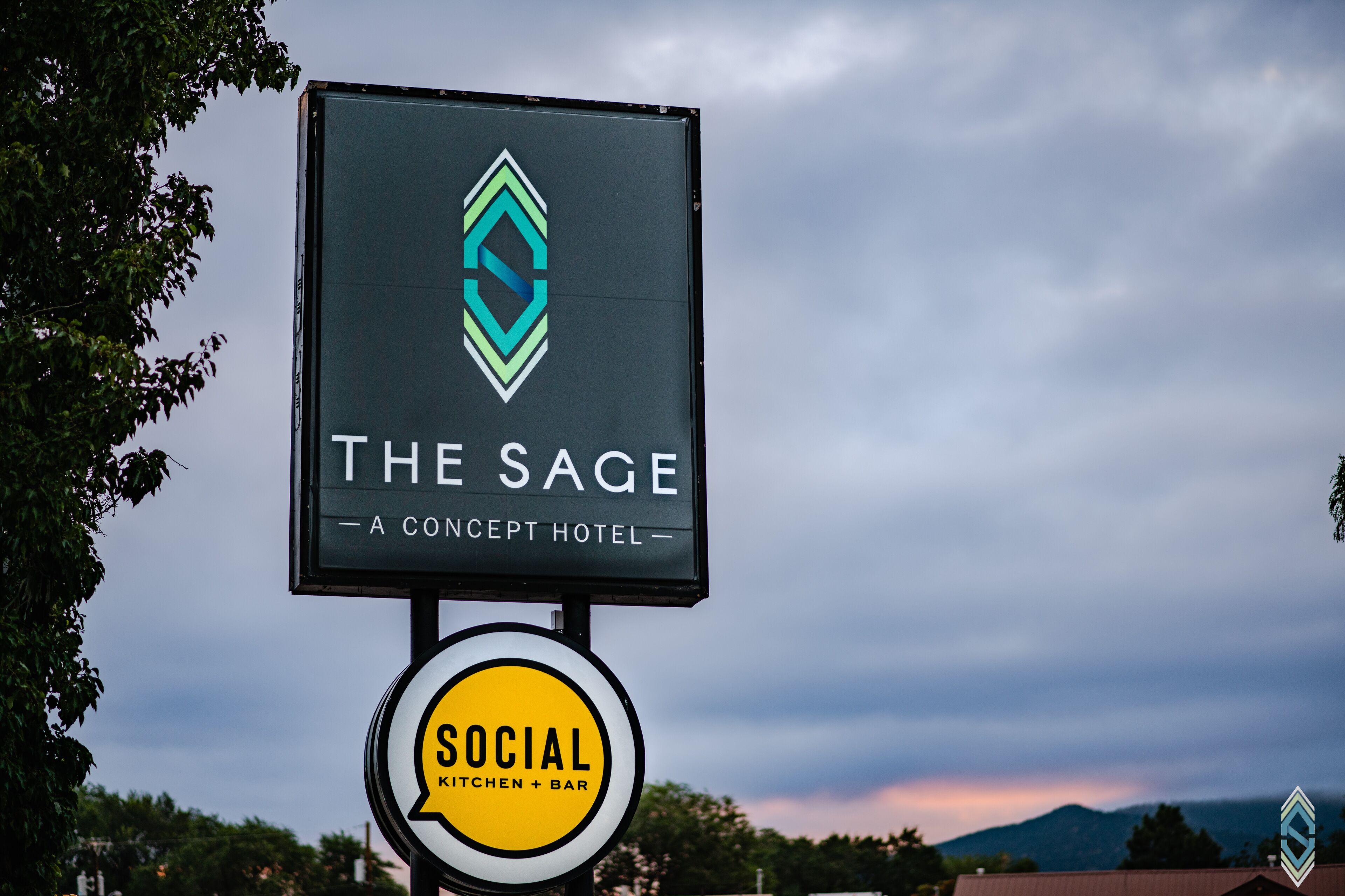 A hotel sign with a logo and name "The Sage - A Concept Hotel".