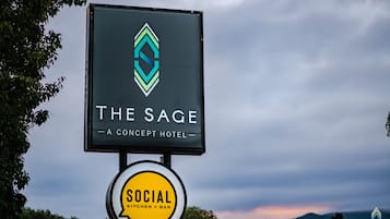 A hotel sign with a logo and name "The Sage - A Concept Hotel".