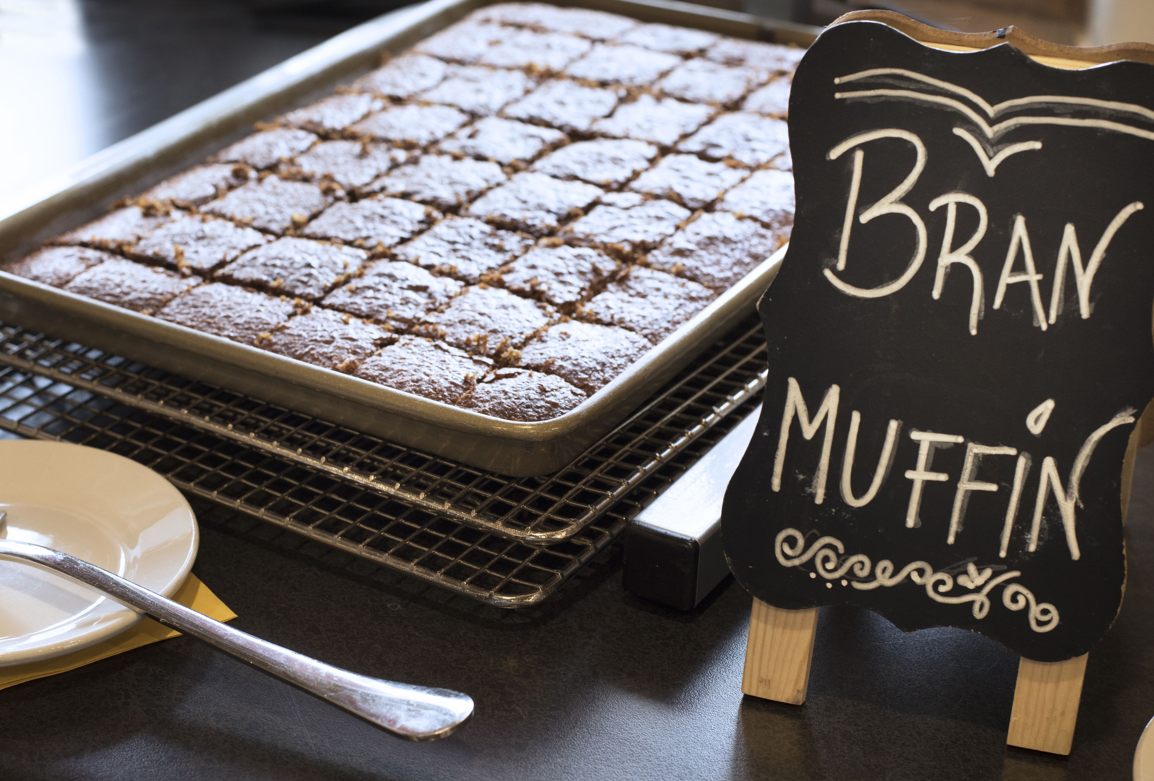 A tray of brownies and a sign that reads "BRAN MUFFIN."