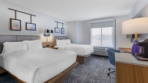 A hotel room with two beds, a desk with a lamp, a chair, and a window with a view. - Sleep Inn South Jordan - Sandy (South Jordan)
