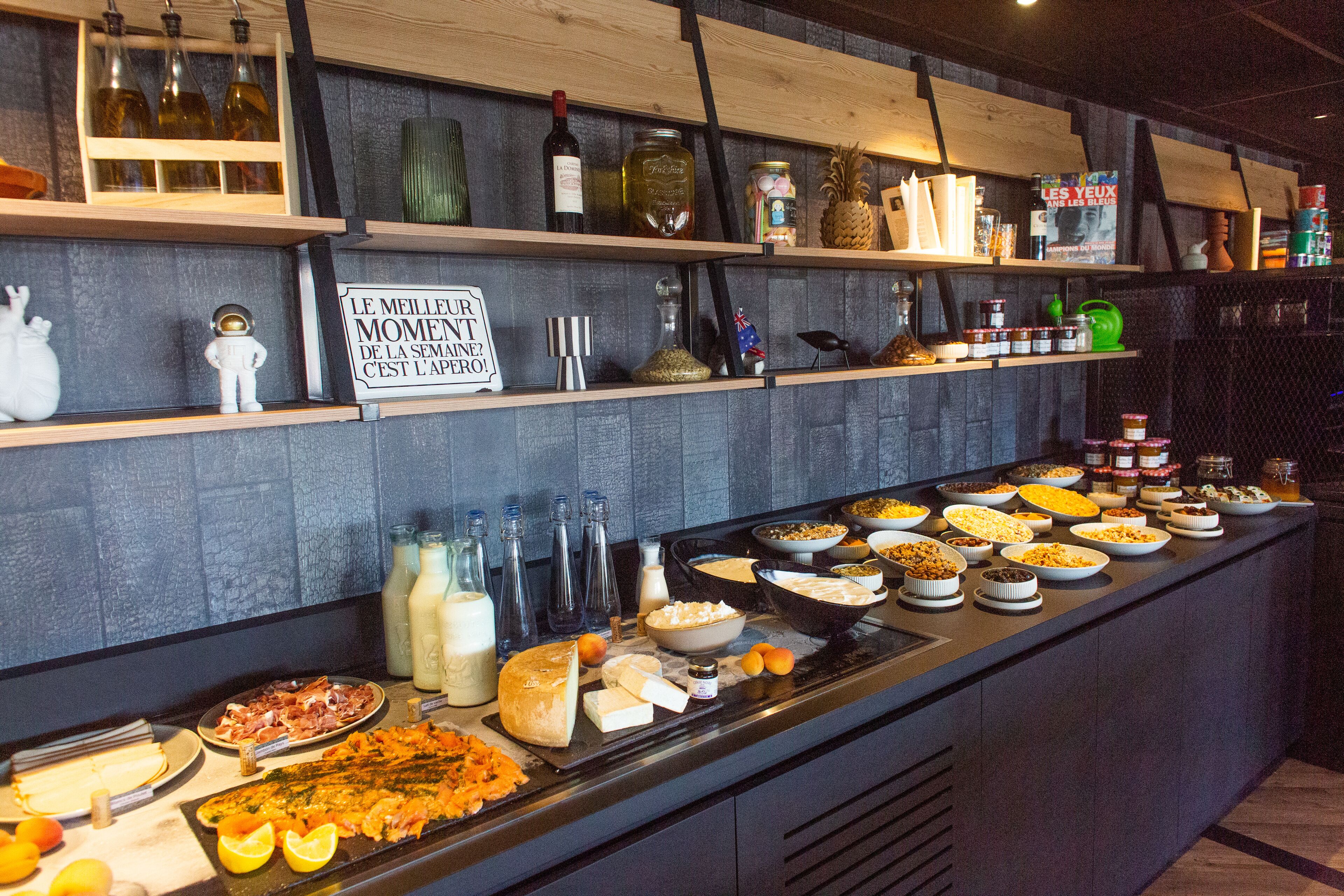 A buffet with various food items and condiments.