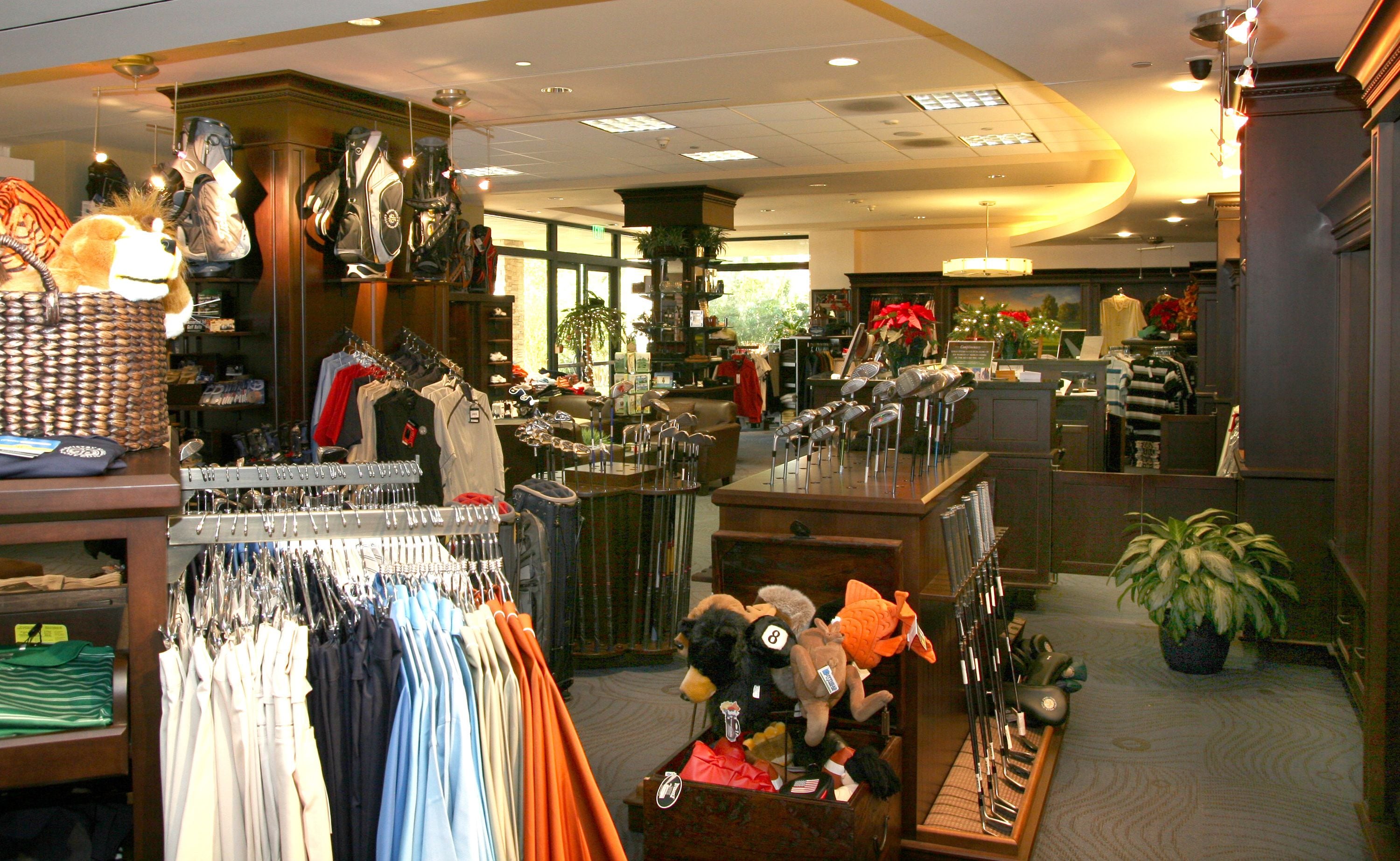 A retail store with various clothing items and accessories on display.