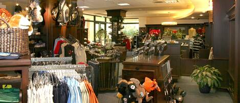 A retail store with various clothing items and accessories on display.