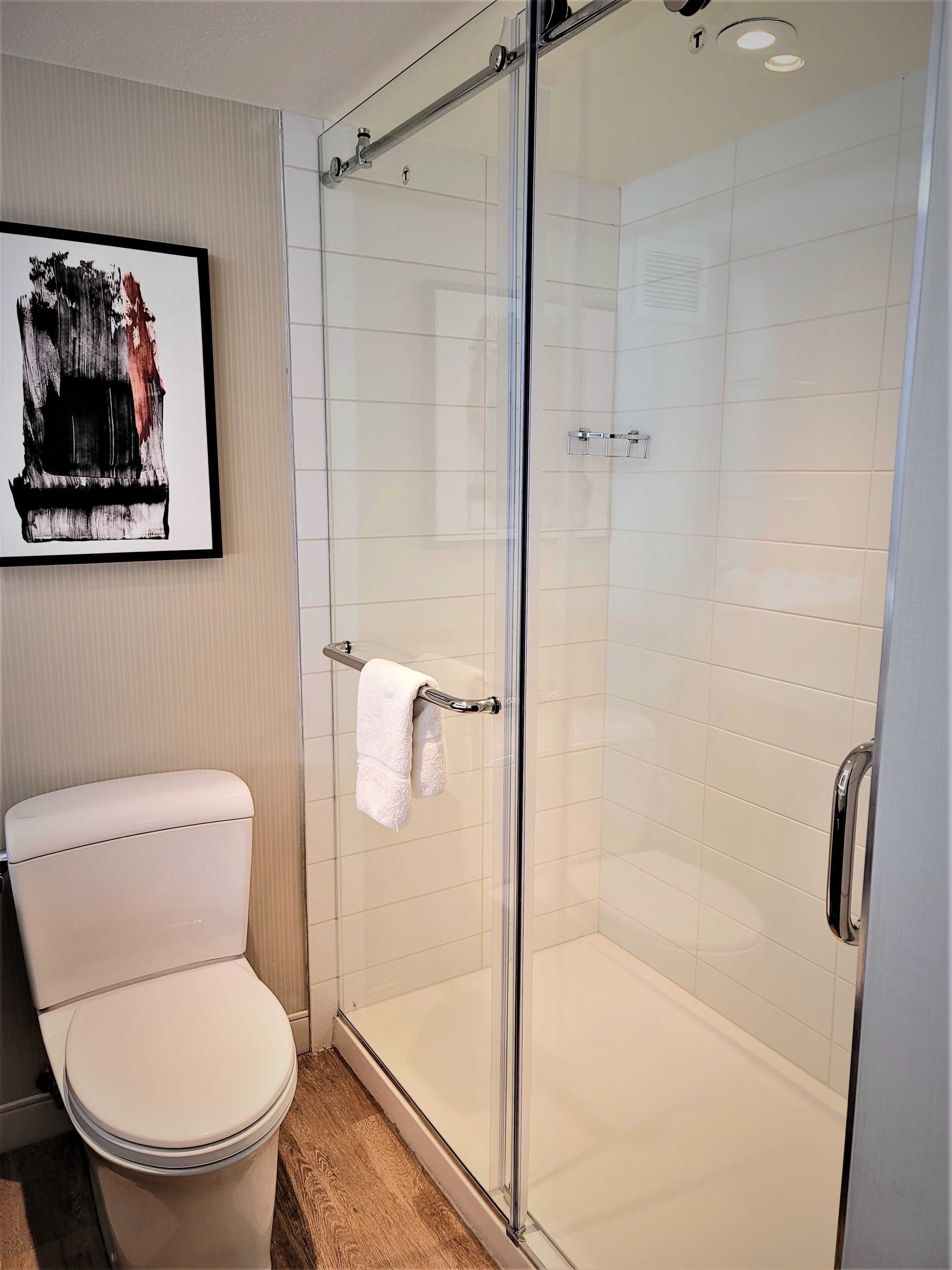 combined shower/bathtub, designer toiletries, hair dryer, towels