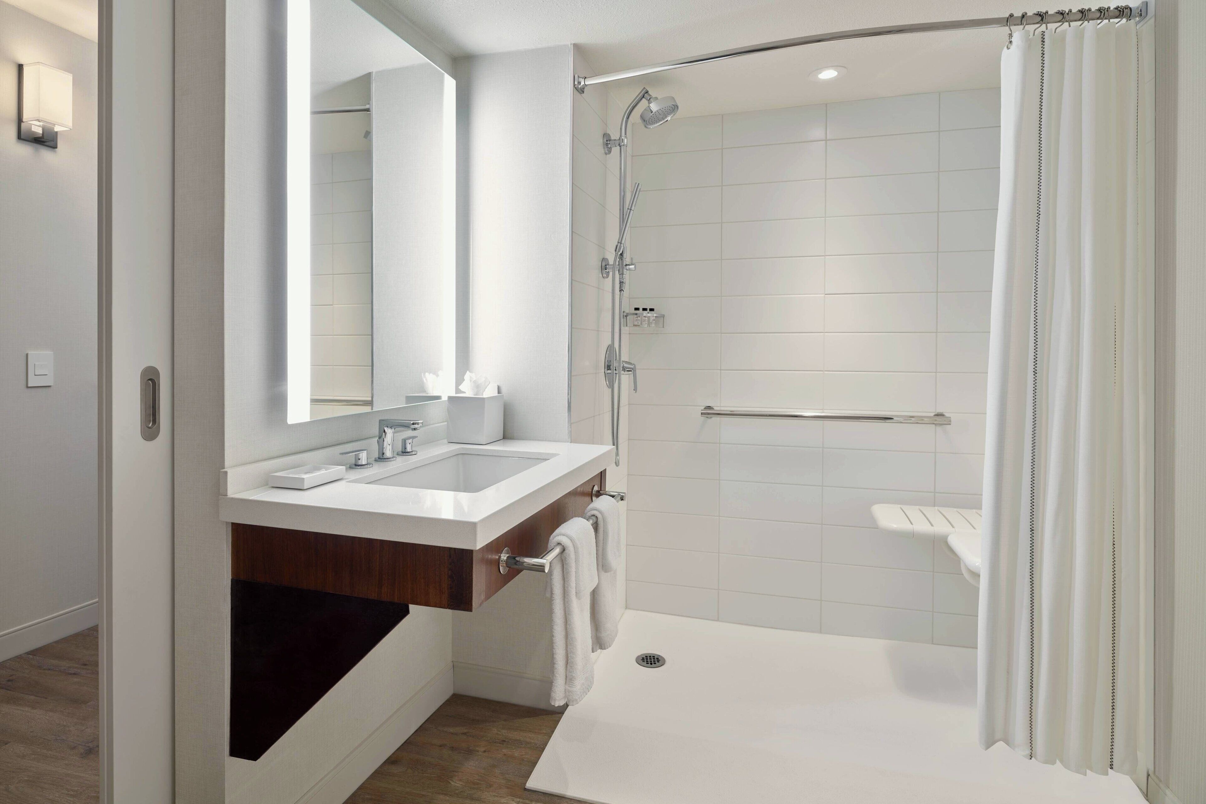 combined shower/bathtub, designer toiletries, hair dryer, towels