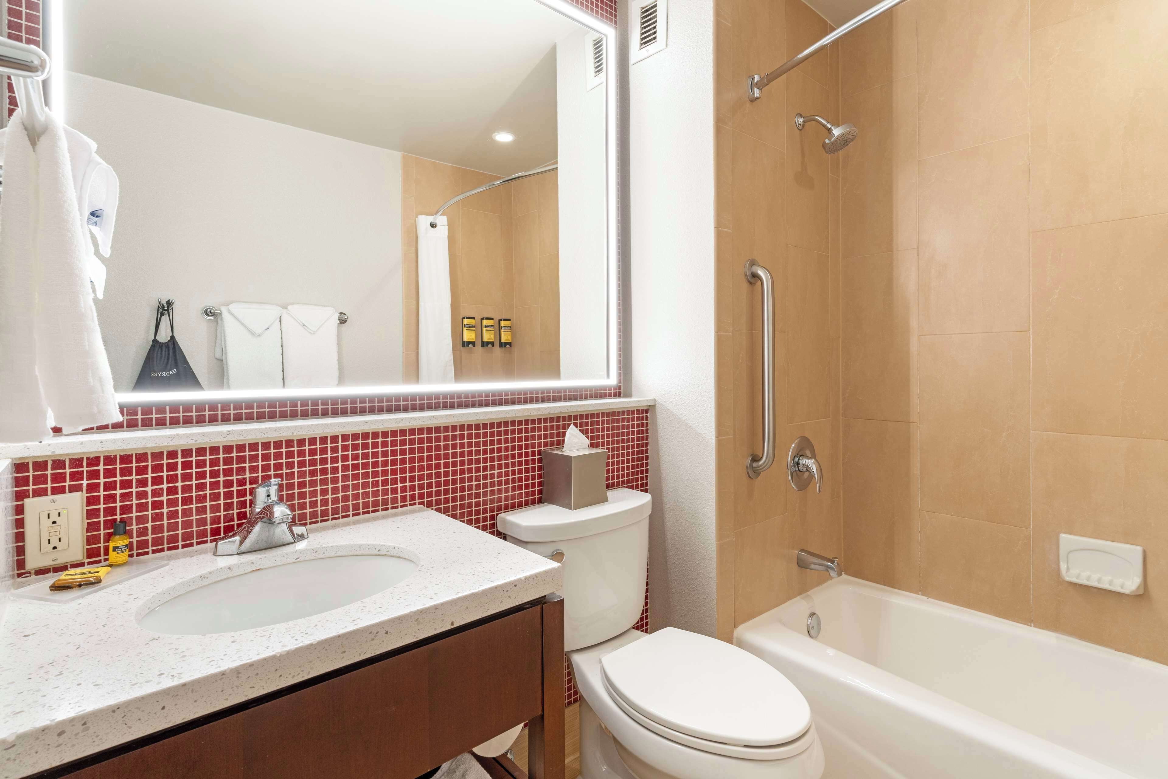 A bathroom with a sink, toilet, and bathtub.