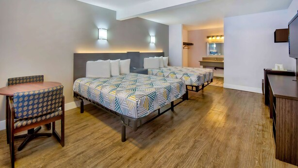 A hotel room with two beds, a desk, and a chair. - Motel 6 Inglewood, CA (Inglewood)
