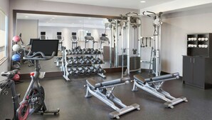 A gym with exercise equipment, dumbbells, and cardio machines. - TownePlace Suites by Marriott London (London)