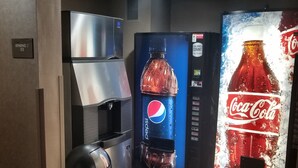 A vending area with a refrigerator, a Pepsi dispenser, and a Coca-Cola dispenser. - Comfort Inn, Erie - Near Presque Isle (Erie)
