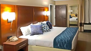 A hotel room with a large bed, a bedside telephone, and a nightstand. - Comfort Inn, Erie - Near Presque Isle (Erie)
